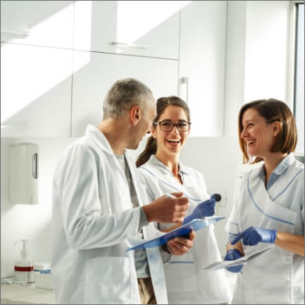 Dental team members laughing together