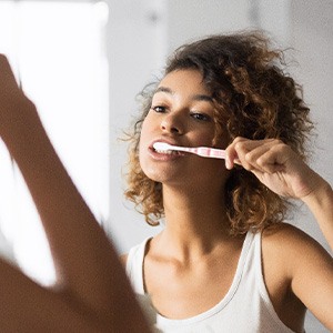 Patient in Hackettstown brushing their dental implants