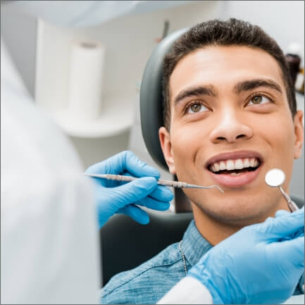 Man smiling during preventive dentistry checkup and teeth cleaning visit