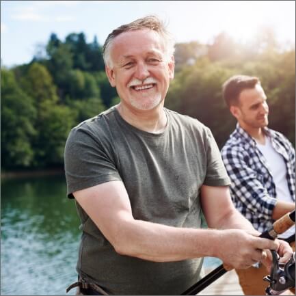 Man smiling after tooth replacement with dental implants