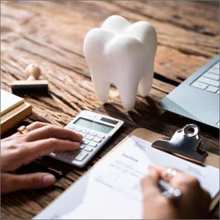 Dentistry patient filling out dental insurance forms