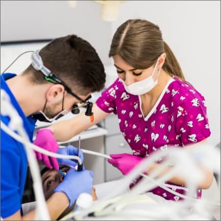 Dentist performing root canal treatment