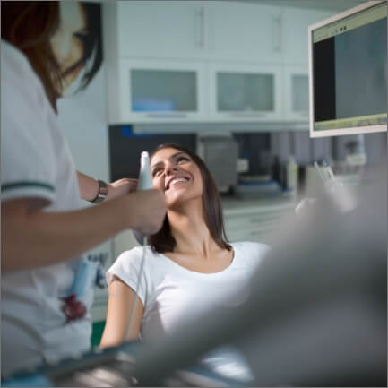 Woman smiling at dentist after root canal treatment