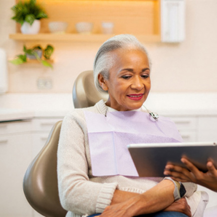 Senior patient talking to dental team member