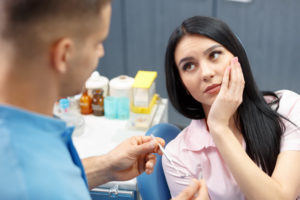 Patient with toothache talking to dentist