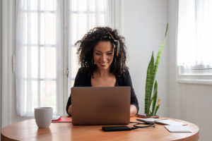 Woman working on laptop at home during quarantine