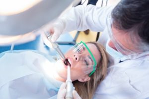 dentist performing root canal therapy on a patient 