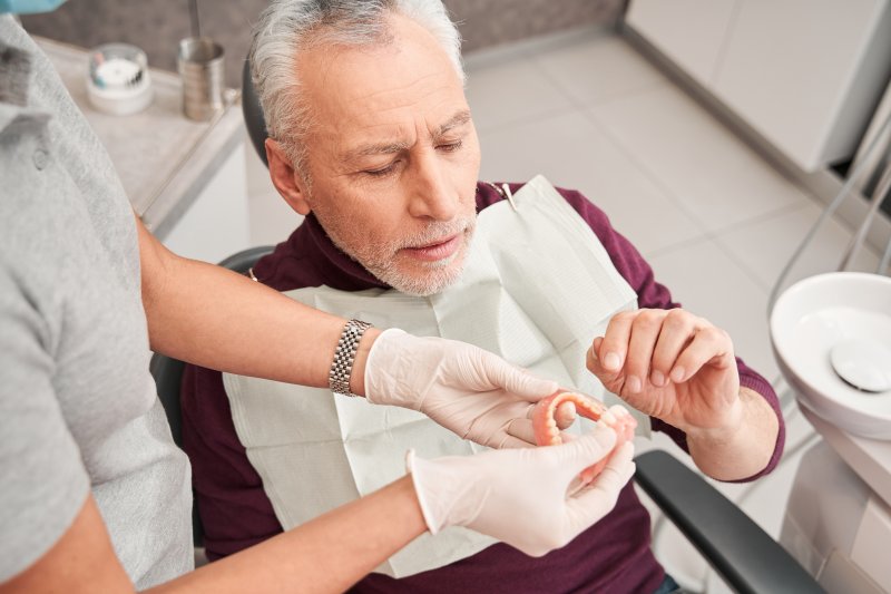 An older man receiving a denture reline