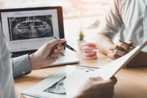 Dentist and patient discussing options over a desk