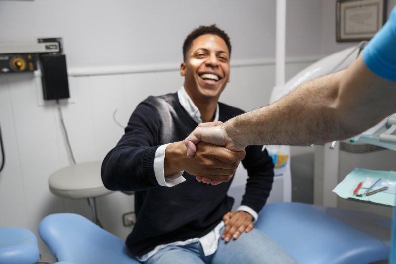 Patient smiling after getting dental implants