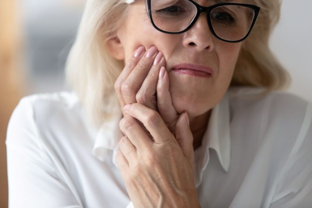 A woman with painful denture sores.